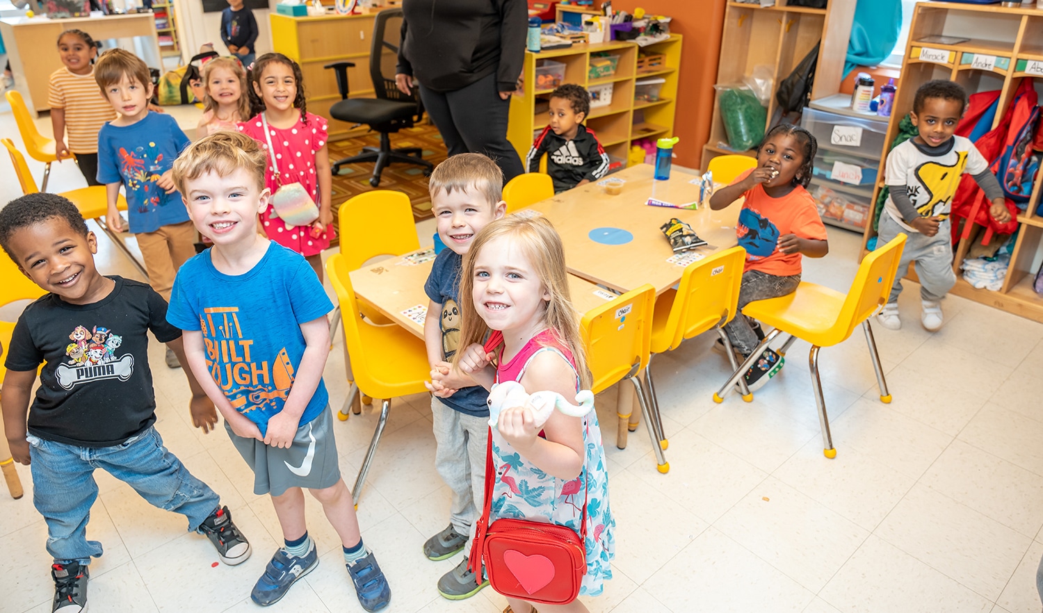 group of young children in classroom smiling