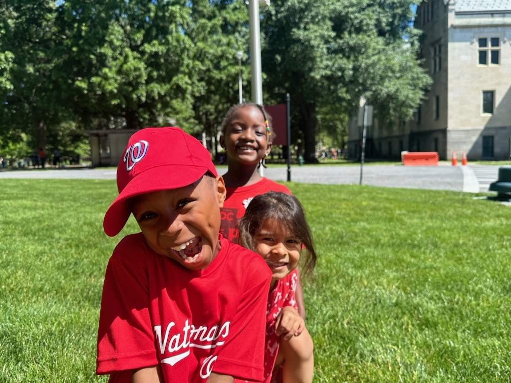 Happy students playing baseball.